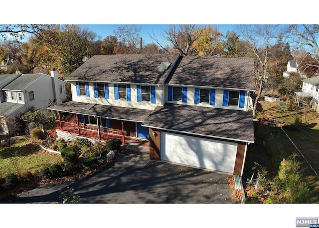 view of front facade featuring a porch and a garage