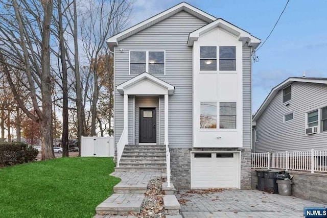 view of front of home featuring a front yard, a garage, and cooling unit