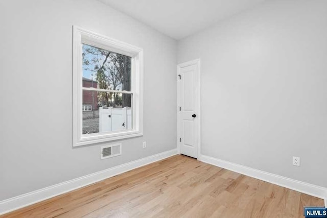 spare room featuring light wood-type flooring