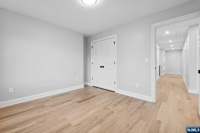 unfurnished room with light wood-type flooring