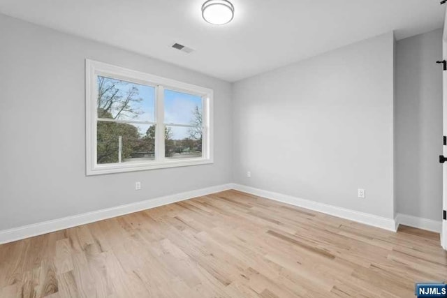 empty room with light hardwood / wood-style flooring