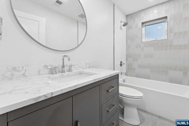 full bathroom with tile patterned flooring, vanity, toilet, and tiled shower / bath