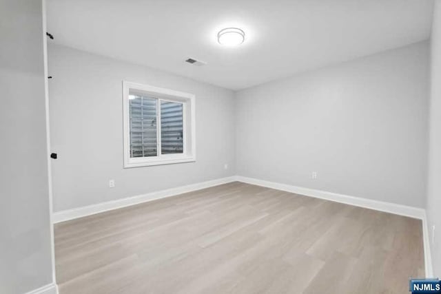 spare room featuring light hardwood / wood-style flooring