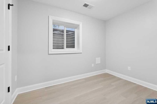 spare room featuring light hardwood / wood-style flooring