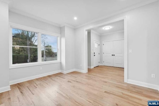 unfurnished room featuring light hardwood / wood-style flooring and ornamental molding