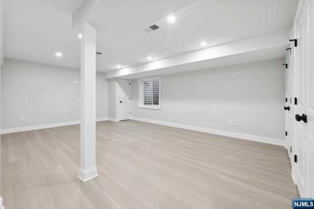 basement featuring light hardwood / wood-style flooring