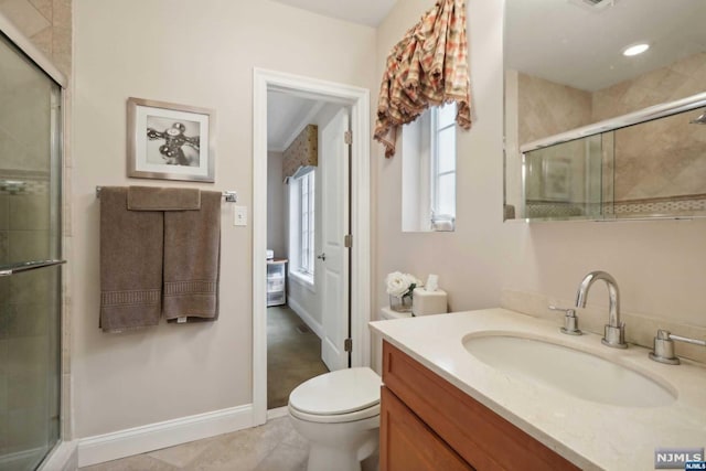 bathroom with tile patterned floors, vanity, toilet, and a shower with door