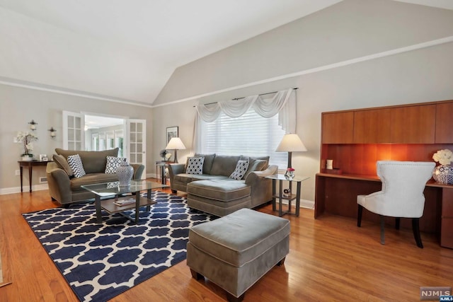 living room featuring vaulted ceiling and hardwood / wood-style flooring