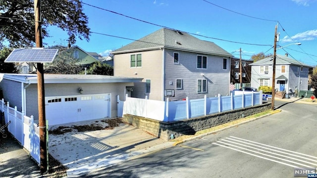 rear view of property with a garage