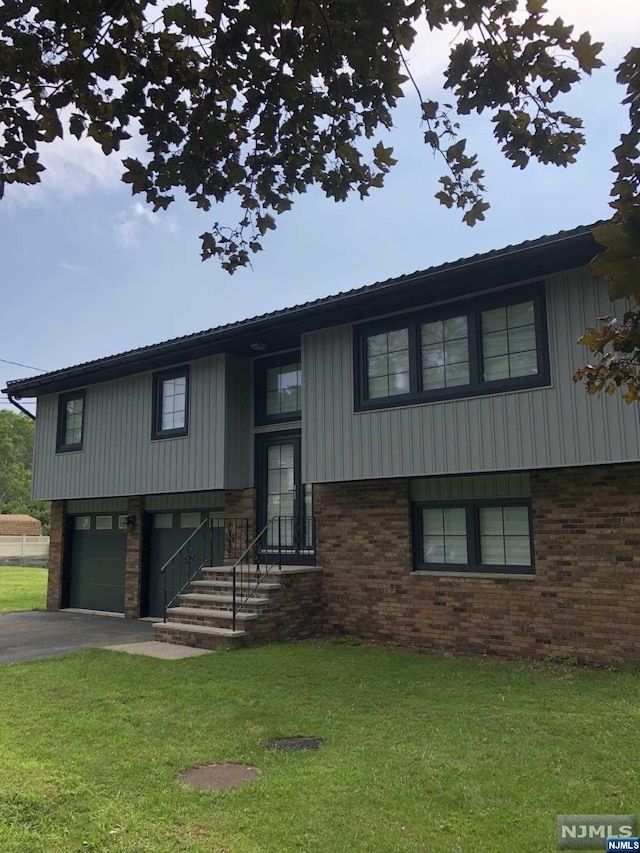 bi-level home with a front lawn and a garage