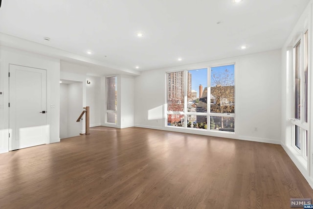 unfurnished living room with dark hardwood / wood-style floors