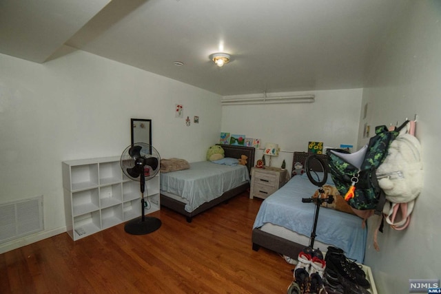 bedroom with hardwood / wood-style flooring