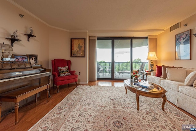 living room with wood-type flooring and crown molding