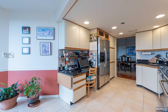 kitchen with white cabinetry and stainless steel fridge with ice dispenser