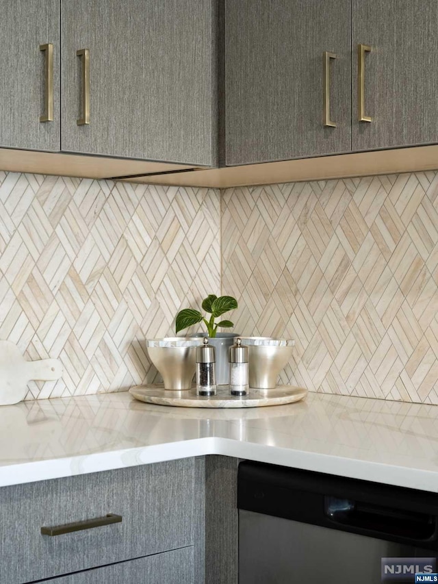 interior details featuring decorative backsplash and dishwasher