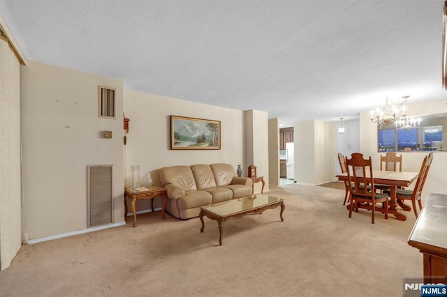 carpeted living room with a notable chandelier