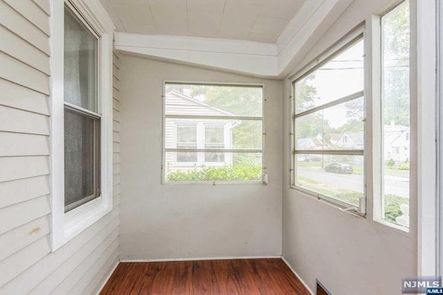 unfurnished sunroom featuring plenty of natural light and vaulted ceiling