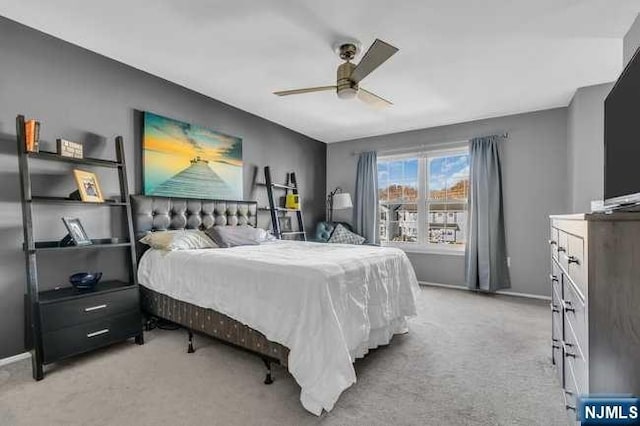 bedroom featuring ceiling fan and light colored carpet