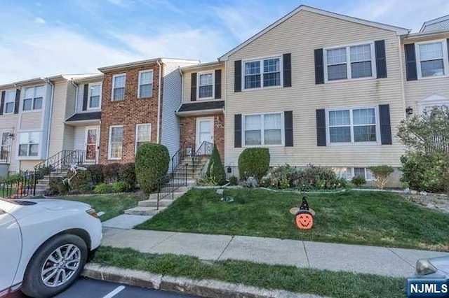 view of property featuring a front yard