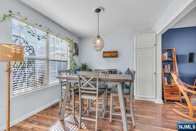 dining area with hardwood / wood-style flooring