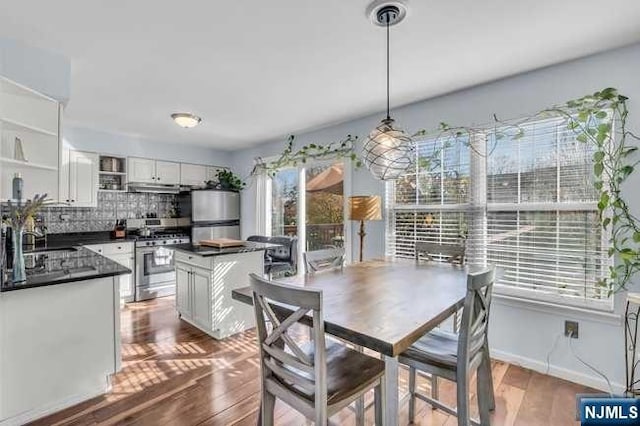 dining space with hardwood / wood-style flooring and sink