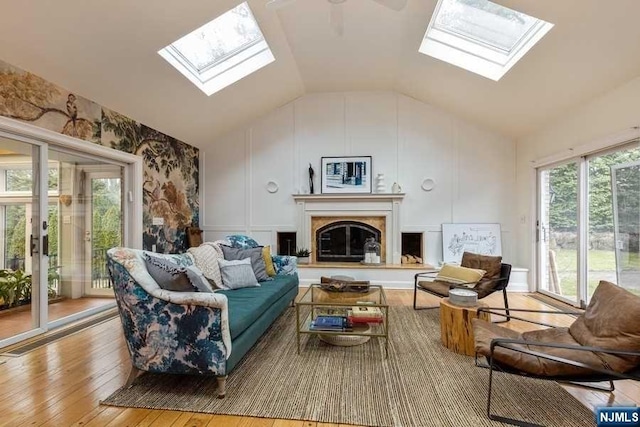 living room featuring light hardwood / wood-style flooring and vaulted ceiling