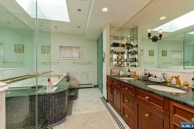 bathroom featuring vanity, a baseboard radiator, plus walk in shower, and a skylight