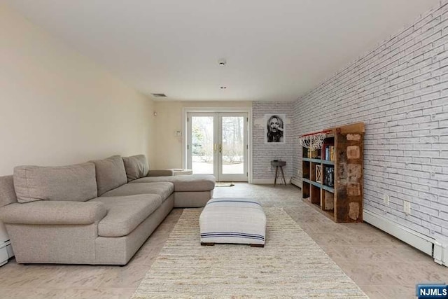 living room featuring french doors and brick wall