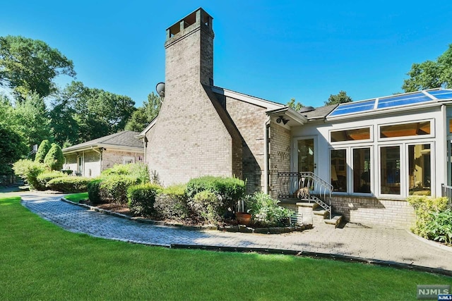 back of house featuring a yard