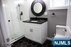 bathroom featuring tile patterned floors, vanity, and toilet