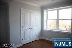 unfurnished bedroom featuring a closet and multiple windows