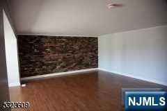 unfurnished living room with wood-type flooring