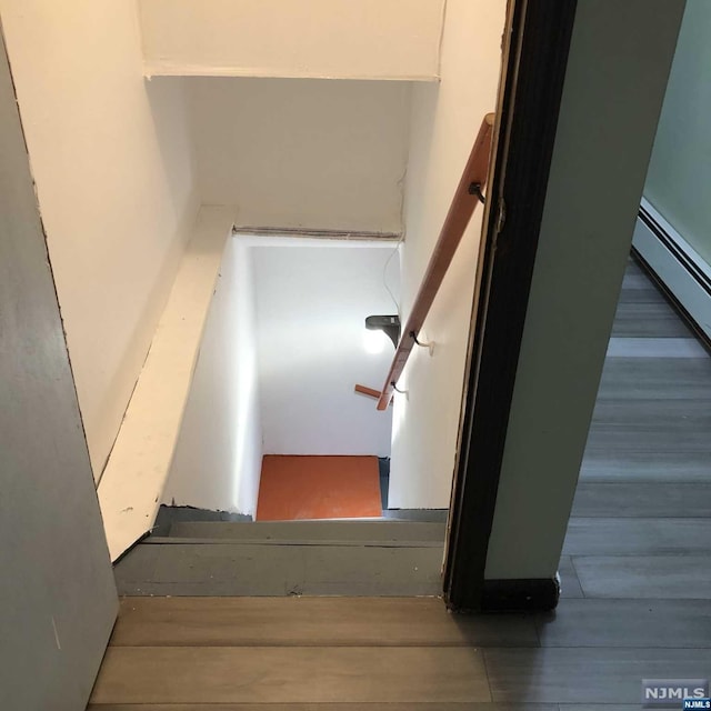 stairs featuring wood-type flooring