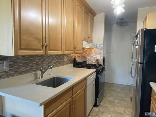 kitchen featuring decorative backsplash, sink, and stainless steel appliances