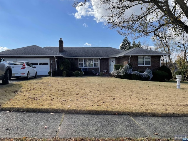 single story home featuring a front lawn and a garage