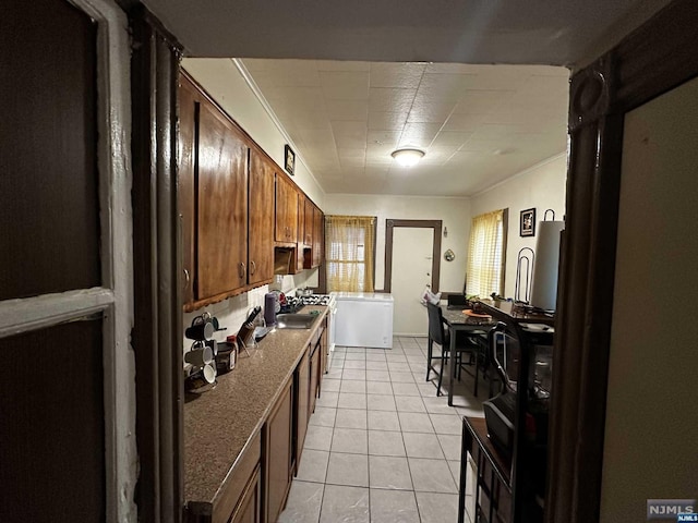 kitchen with light tile patterned floors and sink