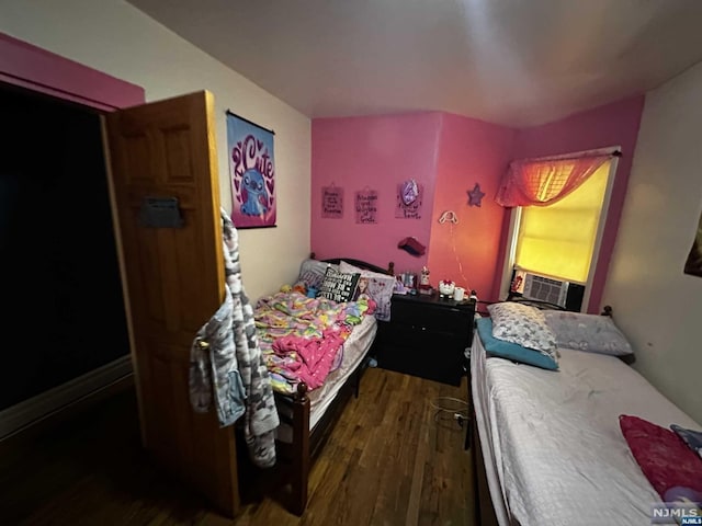 bedroom with dark hardwood / wood-style floors and cooling unit