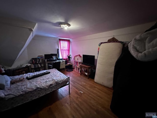 bedroom with wood-type flooring