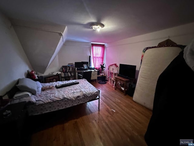 bedroom with dark wood-type flooring