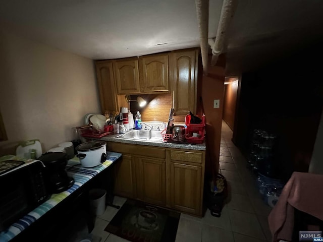 kitchen featuring sink and light tile patterned floors