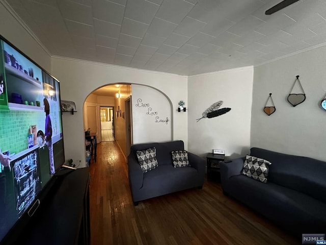 living room with wood-type flooring and ornamental molding