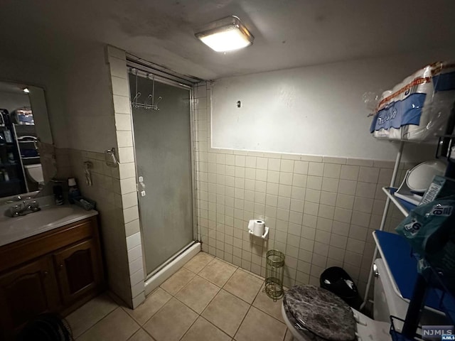 bathroom with tile patterned floors, tile walls, an enclosed shower, and toilet