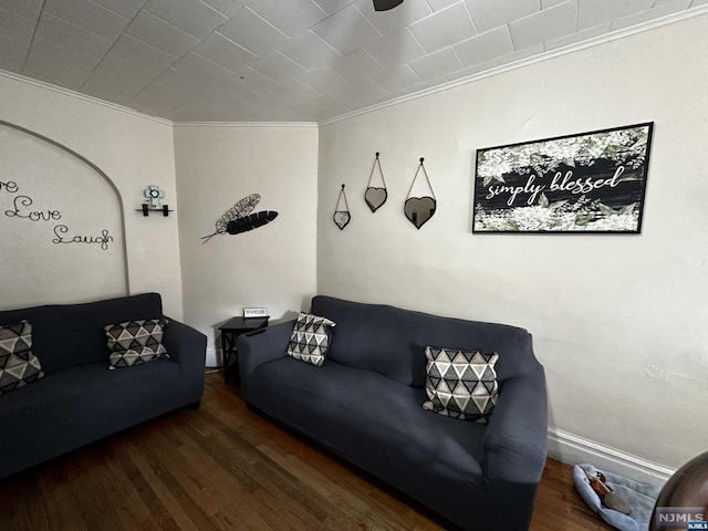 living room with crown molding and dark wood-type flooring