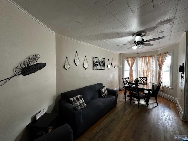 living room featuring ceiling fan, dark wood-type flooring, and ornamental molding