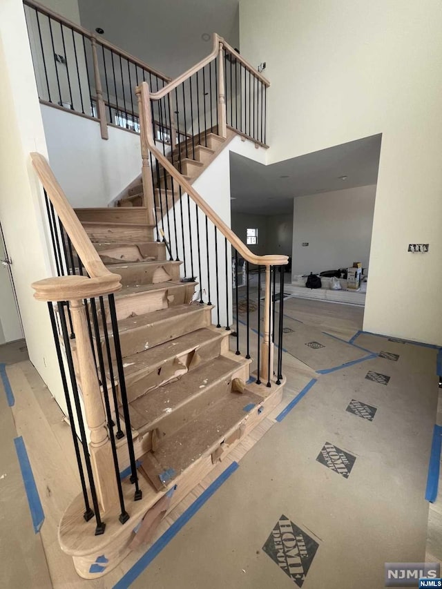 stairs featuring a high ceiling