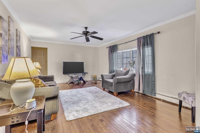 living room featuring ceiling fan, wood-type flooring, and ornamental molding