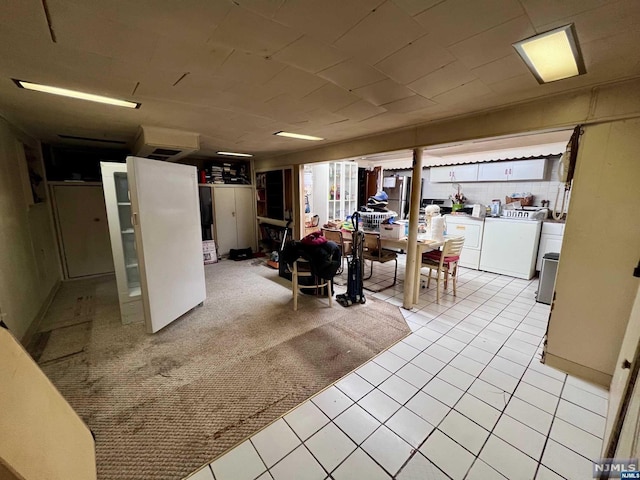 basement with washing machine and dryer, light colored carpet, and plenty of natural light