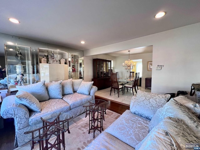 living room with hardwood / wood-style flooring and an inviting chandelier