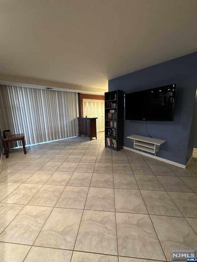 unfurnished living room featuring light tile patterned floors