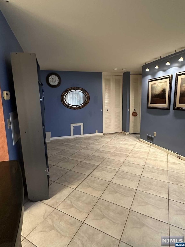 basement with light tile patterned flooring